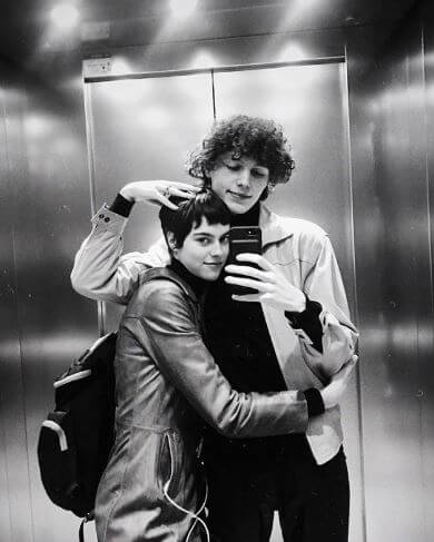 Daan Duez with his girlfriend, Ilona Desmet posing inside an elevator.